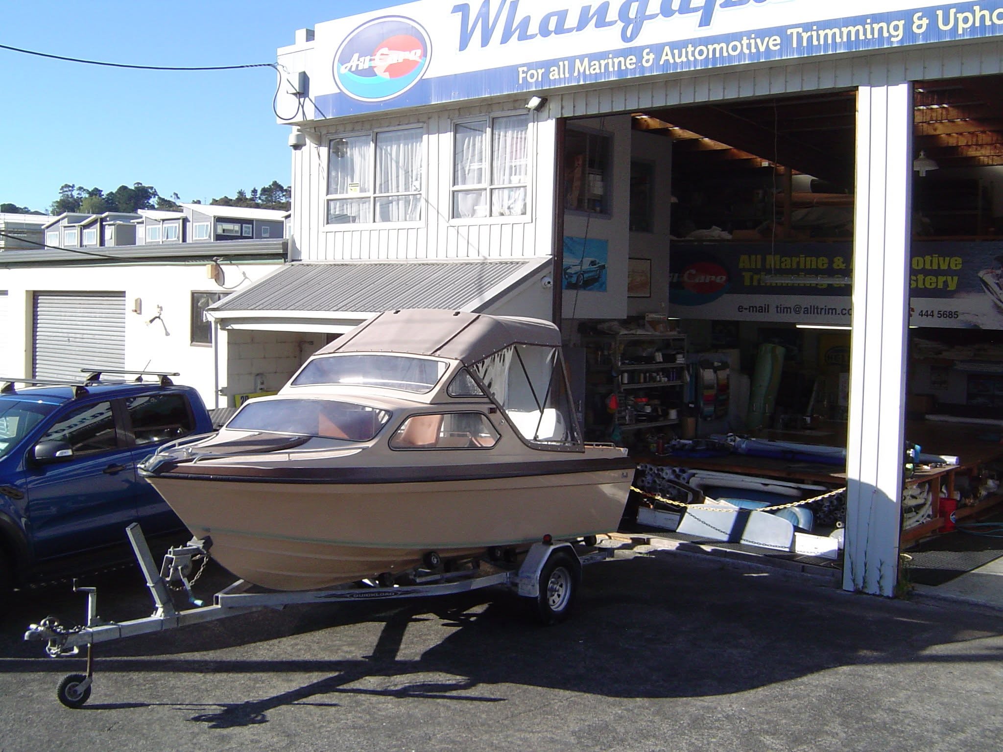 A trailer boat with a new canopy outside the Arklow Lane workshop